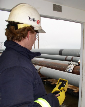 A Photo of TesTex technicians inspecting a pipe